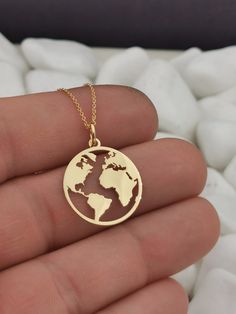 "14k Solid Gold Earth Necklace, World Map medallion Necklace, Gold Coin Globe Necklace, Gold Disc WanderLust Necklace, Globetrotter You Can Choose The Size Of the Pendant Using The 2nd Option Box The Size in the Photos is for 0.75inches (19.1mm) Both Pendant and Chain are 14k Solid Gold ♥ Material of pendant and chain: Solid Gold k14 ♥ Packaging: All of our jewelry is beautifully boxed and ready for gifting For more personalized designs take a look here: ♥ www.etsy.com/listing/631444472 ♥ www.et Gold Round Pendant Necklace For Travel, Gold Necklace With Round Pendant For Travel, Gold Medallion Jewelry For Travel, Gold Engraved Jewelry For Travel, Travel Engraved Gold Jewelry, Earth Necklace, Wanderlust Necklace, Globe Necklace, World Map Necklace