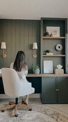 a woman sitting at a desk in an office