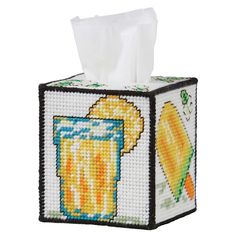 a tissue box with a cross stitch design on it