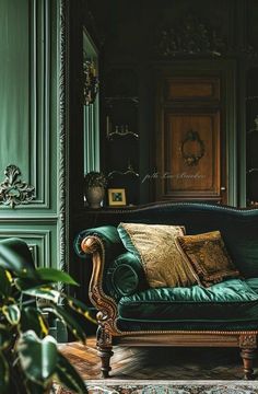 a green couch sitting in front of a wooden table next to a potted plant