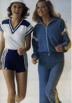 two women in matching tracksuits are running on the beach, one is wearing a sailor's hat