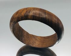 *About me: vintage wooden bangle. I started my life on the beautiful isle of Ibiza, long before it became the sunny party club capital. That said I do like a good party and my rich deep golden brown colouring looks good in any weather, just don't get me wet!  *Size: Approx. length 20cm / 8 inches, width 2.2cm *Weight: Approx. 34.8 grams *Age: Born 1973 *Condition: Good vintage condition, I have a little scrape on my inner from when I was made *Gift boxed to your door ** A vintage item that has b Wooden Bangle, Golden Brown, Vintage Jewellery, Best Part Of Me, About Me, Ibiza, Picture Video, Bangle Bracelets, Vintage Items