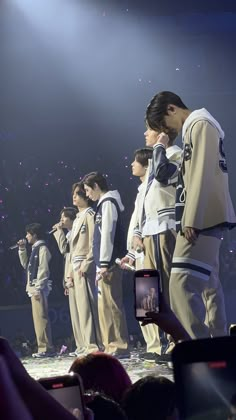 a group of men standing on top of a stage