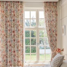 a bed sitting under a window in a bedroom