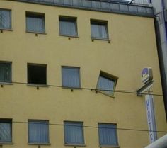 a yellow building with several windows and a sign on the side that says motel 6