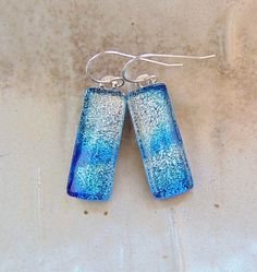 "The stones in these beautiful earrings measure approximately 1\" by 3/8\".  They are hung with sterling silver French wire hooks and hang approximately 1 3/8\".  The dichroic glass in these earrings shimmer with silver and blue on black colored glass.  They are capped with clear and full fused for strength and depth. Thank you for looking in my shop.  All of my pendants and earrings will arrive in a gift box.  I do my best to accurately photograph my work so you will be happy with your purchase. Dichroic Glass changes colors with different lighting and different angles, therefore making it difficult to photograph. You must see my dichroic pieces in hand to appreciate the color and depth of each piece. They are so much more beautiful in person, than in the photographsyou must see to apprec Sterling Silver Blue French Hook Earrings, Blue Sterling Silver Earrings With French Hook, Silver Linear Earrings With French Hook Gift, French Hook Dangle Earrings For Gift, Long Drop French Hook Earrings For Gift, Sterling Silver French Hook Drop Earrings, Nickel Free Long Drop Earrings Gift, Sterling Silver Drop Earrings With Lever Back, Sterling Silver Drop Linear Earrings With Lever Back