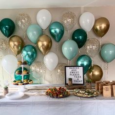 a table topped with lots of balloons and desserts