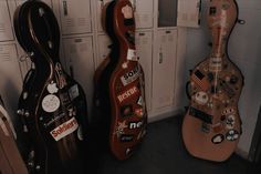 three guitars are lined up next to each other in the lockers at the school