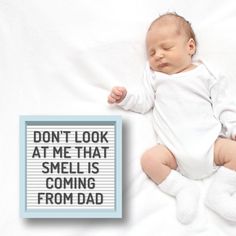 a baby is sleeping next to a sign that says, started from the belly now i'm here