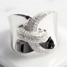 Make a sparkling statement with this white cubic zirconia bypass ring. It is hand set in white sterling silver to highlight its unique design and delicate stone pattern. This ring goes with any look you have planned for any occasion: fancy elegant dinners, casual everyday style, professional workwear, or sexy and romantic dates.- Stones Material: Cubic Zirconia.- Stones Shape: Round.- Metal: 925 Sterling Silver.- Plating: Rhodium plated.Ships in a Balara Gift Pouch.Available in: Silver (sizes: 6 Elegant Dinners, Professional Workwear, Elegant Dinner, Bypass Ring, Stone Pattern, Romantic Dates, Casual Everyday, Band Ring, Everyday Fashion