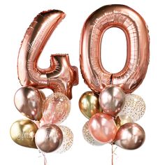 the number sixty is surrounded by balloons in pink and gold colors on a white background