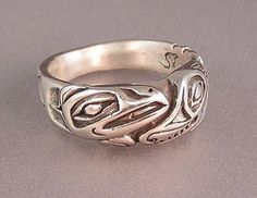 Sterling Silver Wolf & Raven Ring made by Walker Goldsmiths as a tribute to the Haida people. Wolf is a division of the Raven Clan and some people like to wear this ring to show their clan affinity. Some just love Ravens and Wolves because they are the epitome of the wild spirit and so much alike in Symbolic Ceremonial Ring, Ceremonial Symbolic Ring With Polished Finish, Symbolic Sterling Silver Jewelry For Ceremonial Occasions, Symbolic Sterling Silver Rings For Ceremonies, Ceremonial Symbolic Sterling Silver Jewelry, Raven Ring, Raven And Wolf, Wolf Ring, Eagle Ring