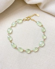 The color of these gorgeous prehnite gems reminds me of the sun shining through new spring leaves. They shimmer and glow with every movement, catching the light in the most enchanting way. I have wire-wrapped each faceted oval gem by hand in 14K gold fill, forming a simple, elegant chain. The extender allows for an adjustable fit for most wrists. Bracelet length: 7 inches plus 1-inch extender Materials: prehnite, gold fill Elegant Faceted Chrysoprase Jewelry, Elegant Green Citrine Jewelry, Elegant Jewelry With Natural Stones And Chrysoprase, Green Moonstone Jewelry With Natural Stones, Elegant Chrysoprase Jewelry With Natural Stones, Green Moonstone Jewelry For Healing, Elegant Peridot Jewelry With Natural Stones, Elegant Adjustable Light Green Jewelry, Delicate Green Jewelry With Natural Stones