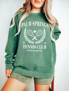 Tennis Club Sweatshirt. These sweatshirts are Comfort Colors. The comfort and style are what this unisex, garment-dyed sweatshirt is all about. It's made with 80% ring-spun cotton and 20% polyester and the fabric is 3-end garment-dyed, ring-spun, color-blast fleece with a 100% cotton face. Each sweatshirt comes with a relaxed fit, a rolled-forward shoulder, and a back neck patch.  ✦ 80% Ring-Spun Cotton, 20% Polyester ✦ Color: Pepper, Light Green, Crimson, Blue Jean, Violet, Blue Spruce, Lagoon Blue, Flo Blue, True Navy ✦ Relaxed fit ✦ Medium-heavy fabric ✦ Sewn-in twill label ✦ Eco-friendly, Ethically Made & Sweatshop Free ✦ Printed to order with non-toxic ink ✦ Durable and Long-lasting ✦ Shirts are pre-shrunk but may shrink slightly after washing ✦ Made to order: *Please allow 2-5 busine Green Crew Neck T-shirt For Leisure, Green Crew Neck T-shirt, Spring Sports Crew Neck Top, Spring Sports Crew Top, Sporty Crew Neck Leisure Top, Sporty Crew Neck Top For Leisure, Green Crew Neck Tops, Green Comfortable Crew Neck Top, Green Comfortable Fit Crew Neck Top