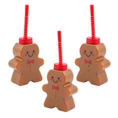 two small plastic gingers with red tops and bows on their heads, sitting side by side