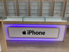 an apple store with the logo on it's display counter and shelves behind it