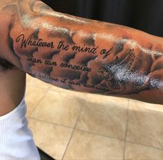 a man's arm with a quote on it that says whatever the mind of man can conquer