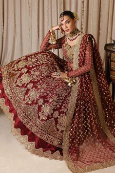 a woman in a red and gold bridal gown