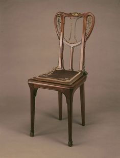 an antique chair that is sitting on a table