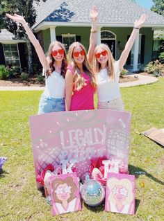 three girls are standing in front of a sign that says legally decorated with balloons and confetti