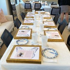 a long table with place settings and plates on it