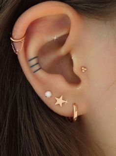 an ear piercing with stars and crescents on the top, in gold or silver