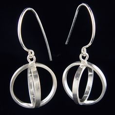 Handmade sterling silver orb dangles were created by making a small circle fit inside of a larger one. Orbs are lightweight and move gracefully on your ear.Size of earring:depth = 0.80 incheswidth = 0.80 inchesheight = 1.45 inches (including ear wire) Hypoallergenic Circular White Gold Jewelry, Hypoallergenic White Gold Circular Jewelry, Everyday Sterling Silver Dangle Jewelry, Modern Round Hypoallergenic Jewelry, Modern Hypoallergenic Round Jewelry, Modern Hypoallergenic Jewelry, Modern Sphere Earrings With Polished Finish, Sterling Silver Sphere-shaped Jewelry, Modern Polished Sphere Earrings