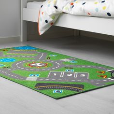 a child's play area rug with cars and trucks on it in a bedroom