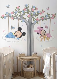 a baby's room with mickey and minnie mouse wall decals