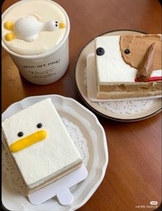 two desserts are sitting on plates next to each other, one with a ducky face