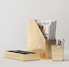 a gold desk set with magazine holders and pencils