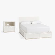 a white bed with two nightstands next to it