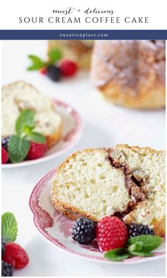 two pieces of cake on plates with berries and raspberries around them, one slice is cut in half