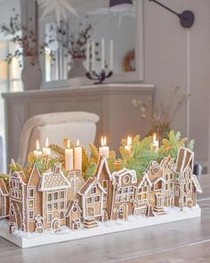 a group of gingerbread houses sitting on top of a wooden table