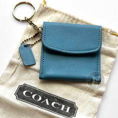 a blue leather case with a key chain attached to it