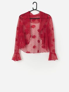 Vintage red lace bolero with floral pattern. This stunning red bolero features a large floral pattern throughout, flared cuffs and is designed to be worn open with no fastenings. Made from a lightweight polyester. Our recommended size: Medium  Label says: 16  Condition: Very good  Material: 100% polyester Measurements in inches: Pit to pit: 19.5 Shoulders: 15.5 Front length: 19 Back length: 20 Sleeve length: 22 Hem: 19 We recommend that you compare our measurements to a similar item of your own Red Bolero, Lace Bolero, Shrugs And Boleros, Red Cardigan, Cool Sweaters, Red Lace, Vintage Wear, Cardigans For Women, Festival Season