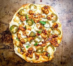 a pizza sitting on top of a pan covered in cheese and veggie toppings