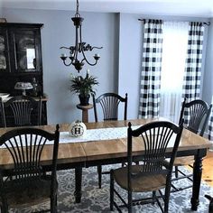 a dining room table with four chairs around it