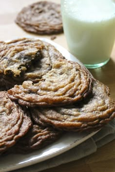 cookies and milk on a table next to a glass of milk