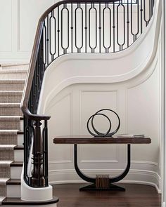 an entryway with a table and stairs in the background, along with carpeted flooring