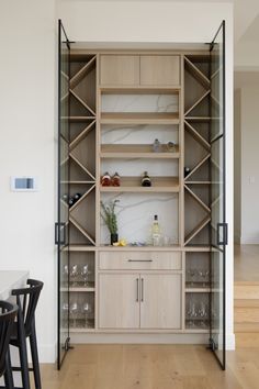 an open bookcase in the middle of a dining room