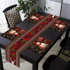 the table is covered with red and black cloths, which are decorated with christmas images