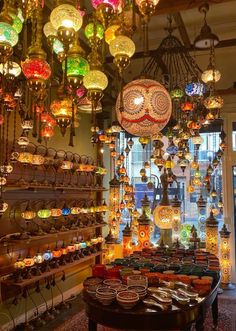 a room filled with lots of colorful lights and hanging decorations on the wall above it