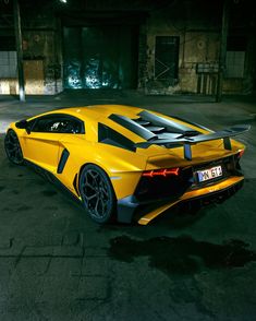 a yellow sports car is parked in an empty parking lot with no one around it