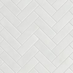 a white tile wall with herringbone pattern