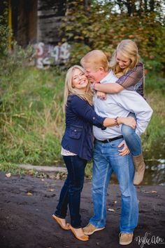 two women and a man hugging each other