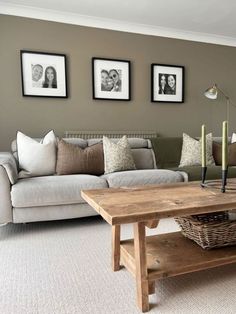 a living room filled with furniture and pictures on the wall above it's coffee table