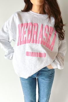 Feeling pretty in pink this new exclusive crew! This sweatshirt is the perfect addition to your spring/summer wardrobe! We are obsessed with this cute sweatshirt! Grey sweatshirt with "Nebraska The Good Life" in pink puff print. Available in small-2XL! cotton polyester machine wash cold hang to dry Life In Pink, Spring Summer Wardrobe, Tailgate Outfit, Black Brick, Feeling Pretty, Pink Lemon, Puff Print, Cute Sweatshirts, The Good Life