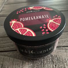 pomegranate ice cream in a black container on a wooden table with the lid open