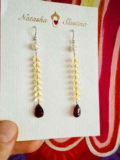 Long golden snakes earrings swing and sway and sparkle with every move. Great for a special occasion like Valentine's Day or even a wedding!  The earrings feature a gsparkly gold plated snake chain, white pearl and a gorgeous dark red garnet drop at the end. Gold Drop Pearl Earrings For Party, Yellow Gold Teardrop Pearl Earrings For Party, Gold Pearl Earrings With Ear Wire For Party, Golden Snake, Snake Earrings, Red Garnet, White Pearl, Snake Chain, Dark Red